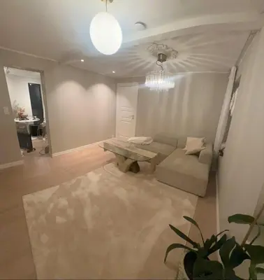 a living room with a couch and a table at leilighet in Bergen