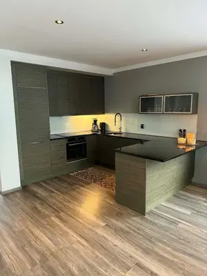 a kitchen with wooden floors and a counter top at Large apartment, in the middle of Gol city center! in Gol