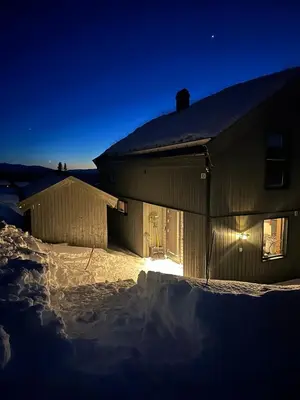 a building in the snow at night at Modern cabin in Rauland with Panorama view in Torvetjørn