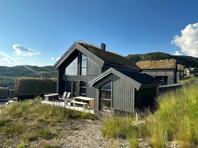 a house sitting on top of a hill at Modern cabin in Rauland with Panorama view in Torvetjørn