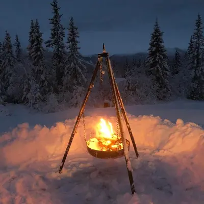 a fire in a basket in the snow at Modern and cozy cabin near ski slopes in Beitostøl