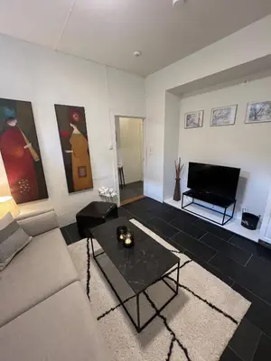 a living room with a couch and a table at Apartment in the heart of Bergen in Bergen