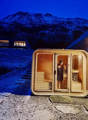 a person standing in a window of a building at 5 Bedroom House at Hakallestranda in Sandvik