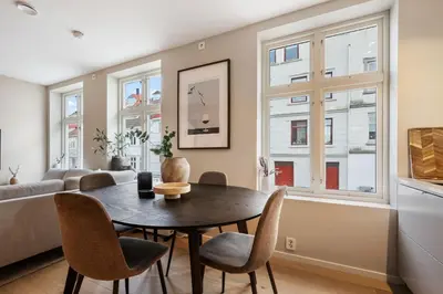 a living room with a table and chairs and a couch at Renovated Apartment in Central Area in Bergen