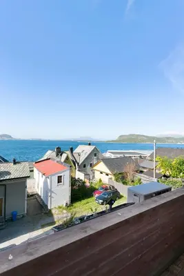 a view of a neighborhood with houses and the ocean at Centrum apartment 1 in Ålesund