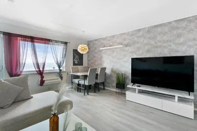 a living room with a large flat screen tv at Centrum apartment 1 in Ålesund