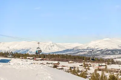 a ski lift handing over a snow covered mountain at Modern apartment in Golsfjellet in Gol