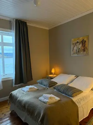 a bedroom with two beds with towels on them at Davik Fjordparadis