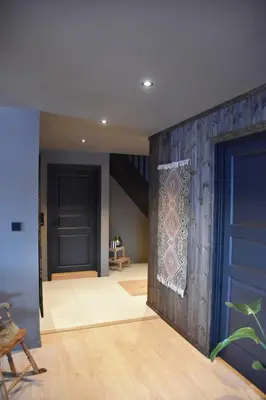 a hallway with a blue door and a rug at luxury home with jacuzzi in Geilo