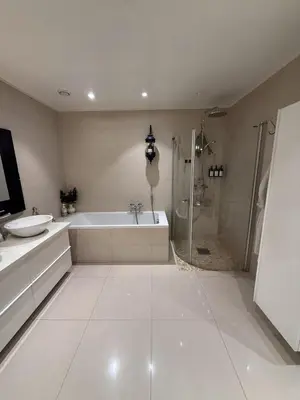 a bathroom with a tub and a sink and a shower at luxury home with jacuzzi in Geilo