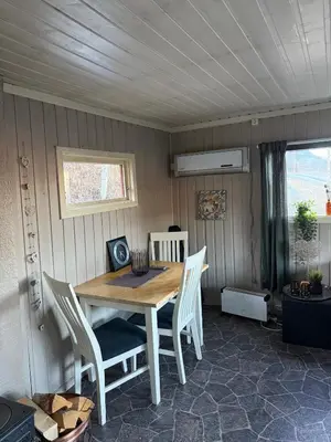a dining room with a wooden table and chairs at Lite hus i Vestre Slidre in Slidre