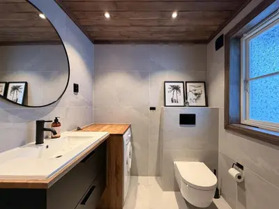 a bathroom with a sink and a toilet and a mirror at Stylish cabin near Hemsedal ski resort, 200 m to slopes & lift in Hemsedal