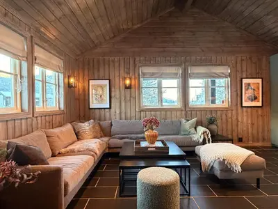 a living room with a couch and a table at Stylish cabin near Hemsedal ski resort, 200 m to slopes & lift in Hemsedal