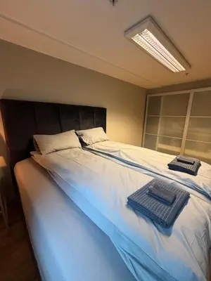 a bedroom with a large bed with two towels on it at Modern apartment in central Trondheim in Trondheim