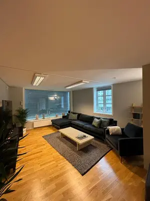 a living room with a couch and a table at Modern apartment in central Trondheim in Trondheim