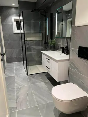 a bathroom with a shower and a toilet and a sink at Nordic Apartment near by the city in Bergen