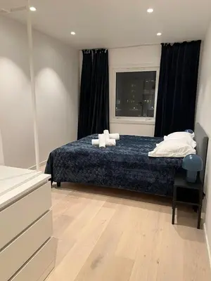 a bedroom with a bed with two pillows and a window at Nordic Apartment near by the city in Bergen