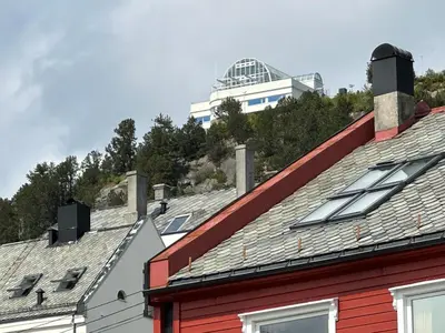 a group of roofs with a building in the background at Apartment centrally with garage and terrace in Ålesund