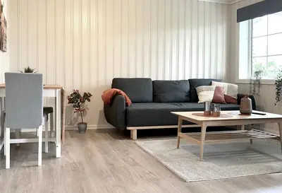 a living room with a blue couch and a table at Apartment centrally located in Bud in Bud
