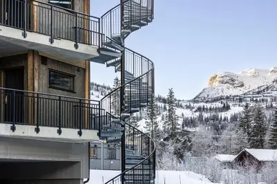 a stairway leading up to a building with snow at Modern ski-in-ski-out apartment in Hemsedal in Hemsedal