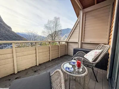 a balcony with chairs and a table with a table at Holiday Home Høyanger Panorama by Interhome in Høyanger