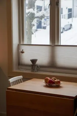 a bowl of fruit on a table in front of a window at Charming apartment with balcony and view! in Ålesund
