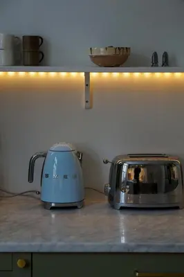 a toaster sitting on top of a kitchen counter at Charming apartment with balcony and view! in Ålesund