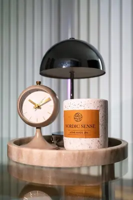 a clock and a candle on a table with a clock at Apartment in the heart of Bergen in Bergen