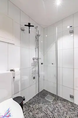 a bathroom with a shower with a glass door at Apartment in the heart of Bergen in Bergen