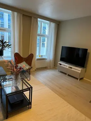 a living room with a large flat screen tv at Cozy apartment in the middle of Bergen city center in Bergen