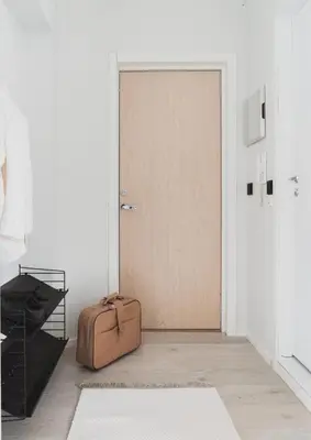 a suitcase sitting on the floor next to a door at Cozy apartment in the middle of Bergen city center in Bergen
