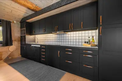 a kitchen with black cabinets and a counter top at Cabin in Hovden with Beautiful views in Bykle