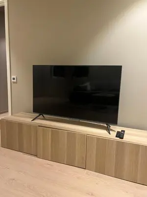 a flat screen tv sitting on top of a entertainment center at Nyoppusset leilighet i sentrum in Verdal
