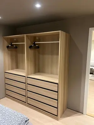 a closet with wooden shelves in a bedroom at Nyoppusset leilighet i sentrum in Verdal