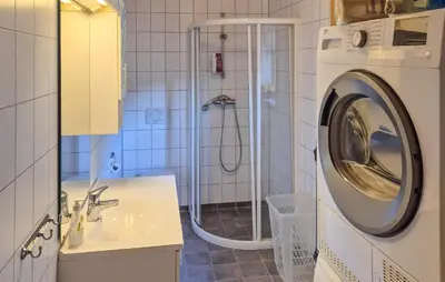 a bathroom with a shower and a washing machine at 3 Bedroom Stunning Home In Tansøy in Tansøy