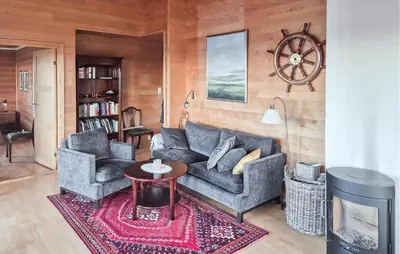 a living room with two couches and a table at 3 Bedroom Stunning Home In Tansøy in Tansøy