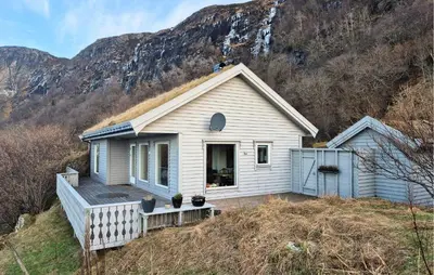 a small white house on top of a hill at 3 Bedroom Stunning Home In Tansøy in Tansøy