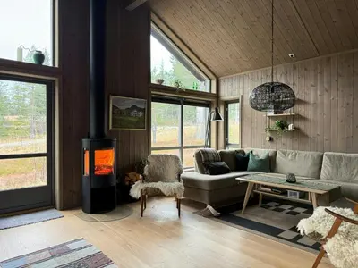 a living room with a couch and a fireplace at Cabin With Sauna At Norefjell in Noresund