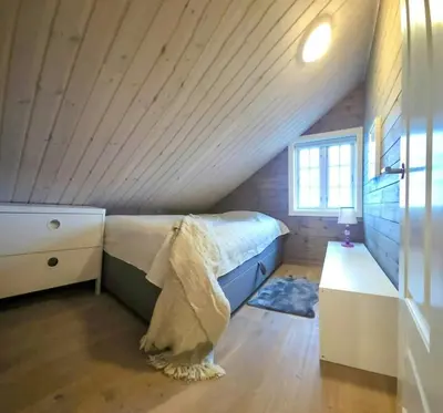 a attic bedroom with a bed and a window at Well-Equipped Cabin Near Rauland Alpine Centre in Rauland
