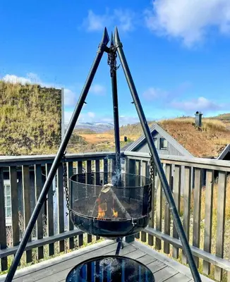 a fire pit on top of a balcony at Well-Equipped Cabin Near Rauland Alpine Centre in Rauland