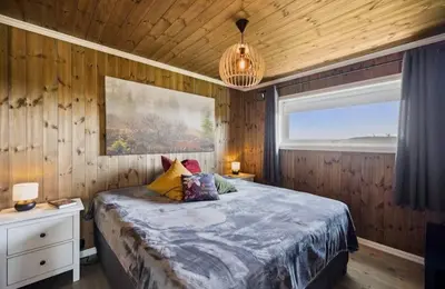 a bedroom with a bed and a large window at Family Cabin BUDOR - 60 MIN FROM OSL - Alpine Cross Country Skiing in Løten