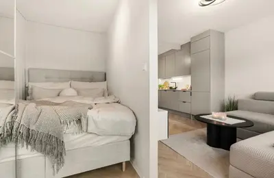 a bedroom with a bed and a table in a room at Modern and cozy apartment ONLY 5 minutes from City Center in Bergen