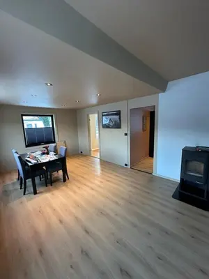 a living room with a table and a tv at Great apartment overlooking Bergen in Bergen