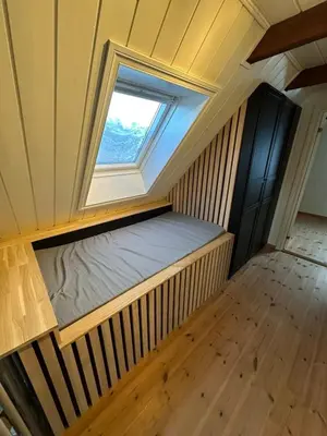 a small room with a bed and a window at Great apartment overlooking Bergen in Bergen