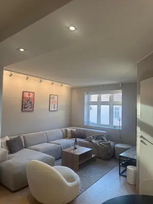 a living room with a couch and a table at Stylish 2BR with Patio and Smart TV - 10 min to Bryggen in Bergen