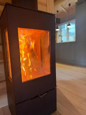 a woodburning stove in a room in a room at Gunhild-stugu i Jotunheimen