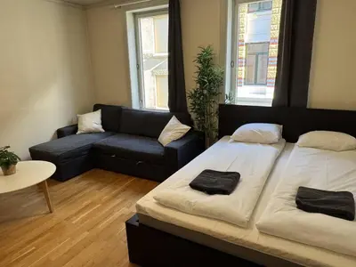 a living room with a bed and a couch at Cozy Studio in Lademoen, Trondheim in Trondheim