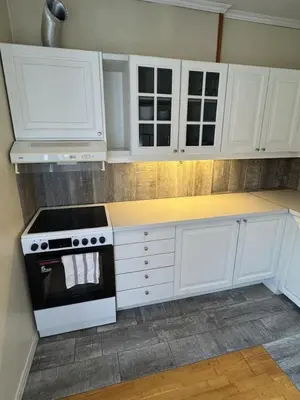 a kitchen with white cabinets and a stove top oven at Cozy Studio in Lademoen, Trondheim in Trondheim