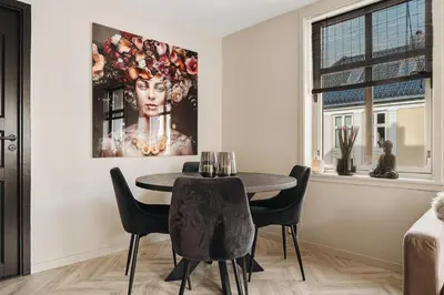 a dining room with a table and chairs at Central apartment building in Bergen