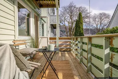 a balcony with a table and a chair at Cozy Apartment near City Centre in Bergen